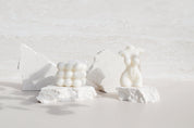 naked lady and cube candles on white limestone stone props with creamy travertine stone waterproof photography backdrop - backdrop collective australia