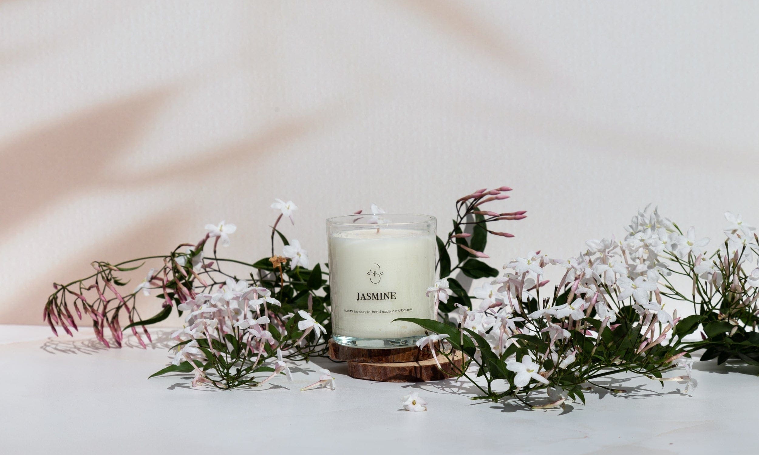 beige Shadow pattern double-sided vinyl photography backdrop photographed with jasmine flowers and jasmine candle - backdrop collective australia